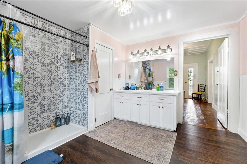 475 Evergreen Road Northeast Resaca, GA 30735 - Photo 30 of 44 a spacious bathroom with a double vanity sink a large mirror a shower and a bathtub