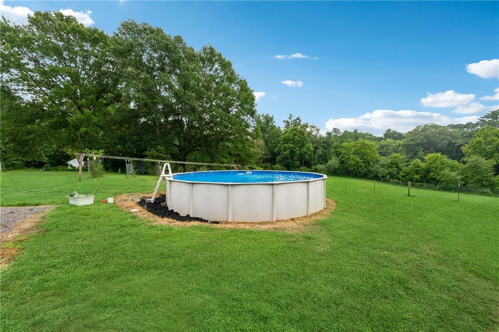 475 Evergreen Road Northeast Resaca, GA 30735 - Photo 8 of 44 a view of a swimming pool with a yard