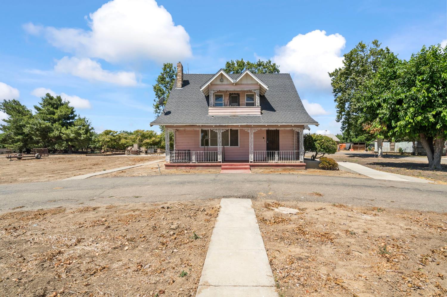 a view of a white house with a yard