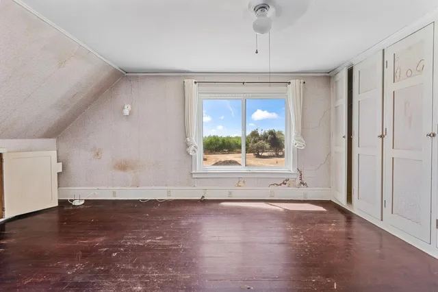 a living room with furniture and a dining table with wooden floor