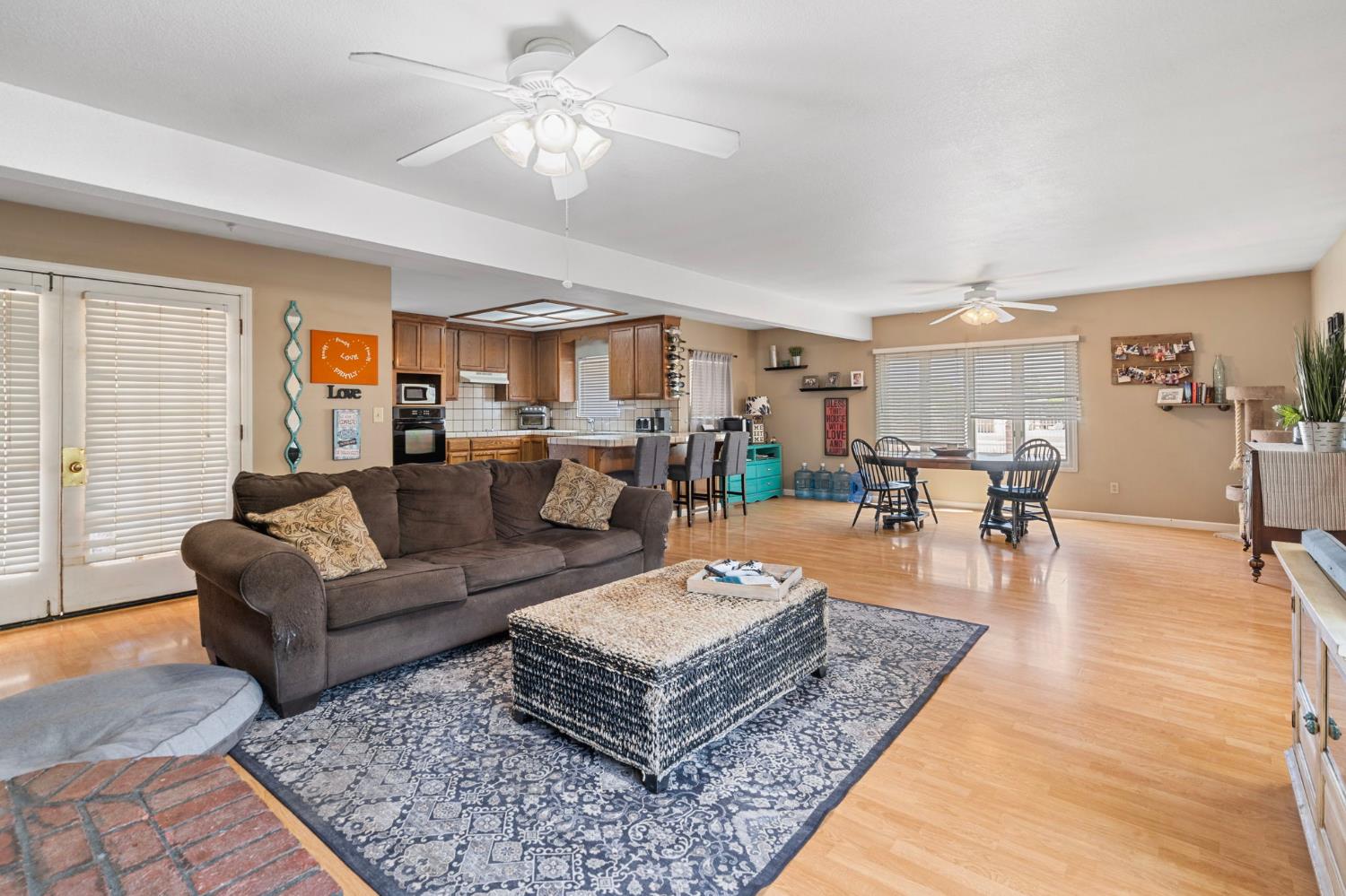 3101 River Road Vernalis, CA 95385 - Photo 46 of 81 a living room with furniture and a dining table with wooden floor