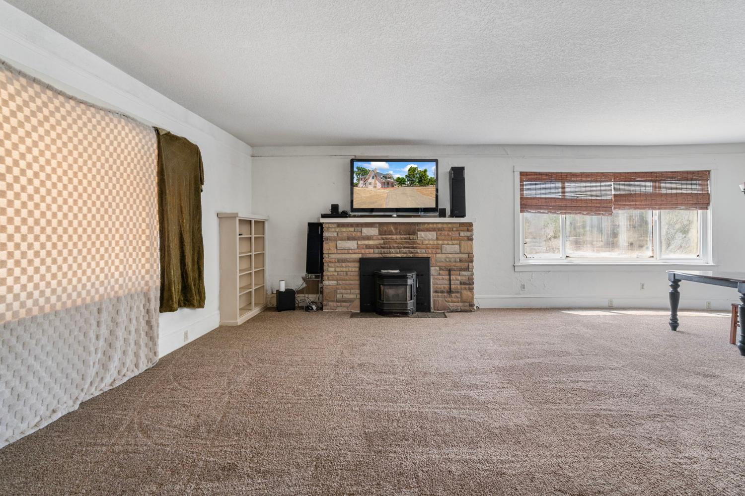 3101 River Road Vernalis, CA 95385 - Photo 7 of 81 a view of an empty room with a fireplace and a window