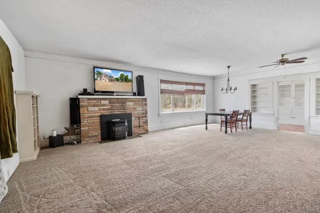 a view of a hallway with wooden floor and windows