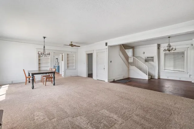 a kitchen with granite countertop a stove a sink and a refrigerator