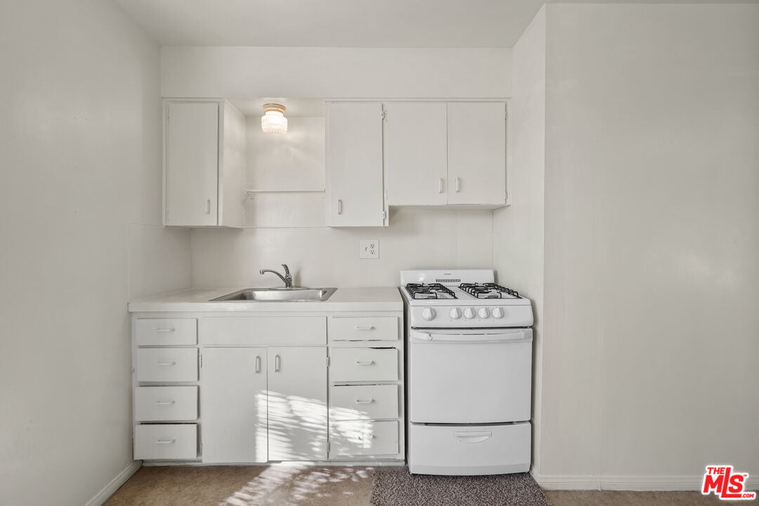 351 Temple Avenue, Unit A Long Beach, CA 90814 - Photo 9 of 18 a kitchen with cabinets appliances and wooden floor