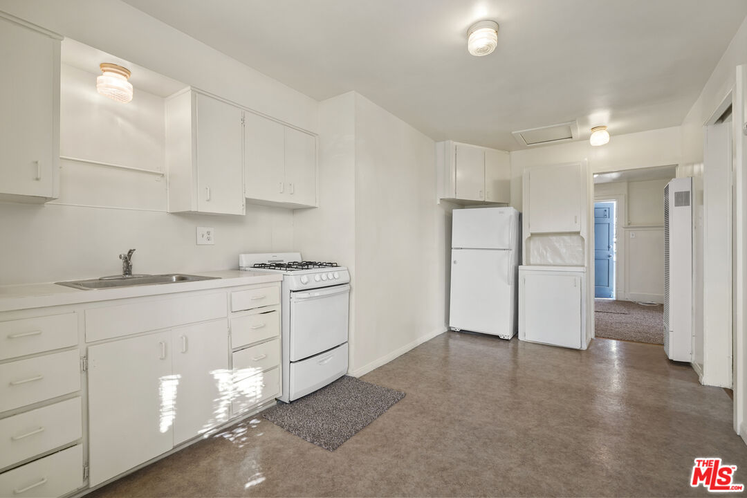 351 Temple Avenue, Unit A Long Beach, CA 90814 - Photo 10 of 18 a kitchen with white cabinets and refrigerator