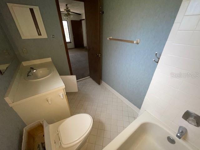 7 Brookside Circle Ormond Beach, FL 32174 - Photo 13 of 16 a white toilet sitting next to a bathroom sink and a tub
