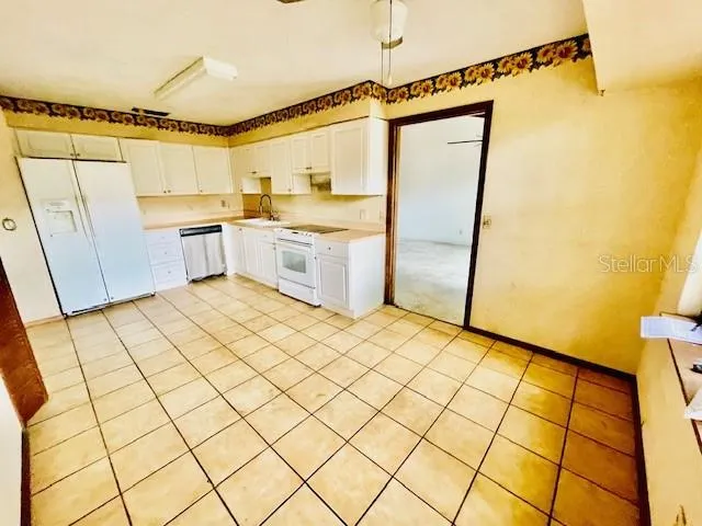 a kitchen with a sink a counter top space and appliances