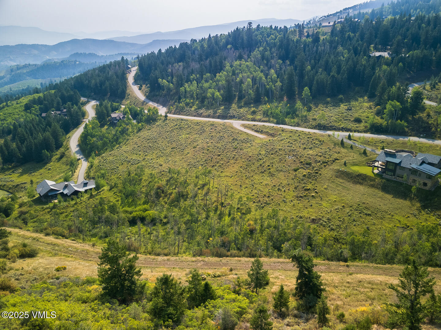 a view of a town with mountains in the background