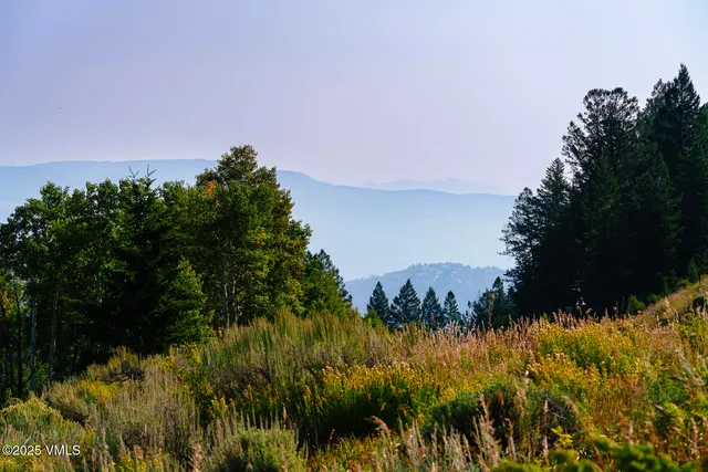 a view of a large body of water with a house in the background