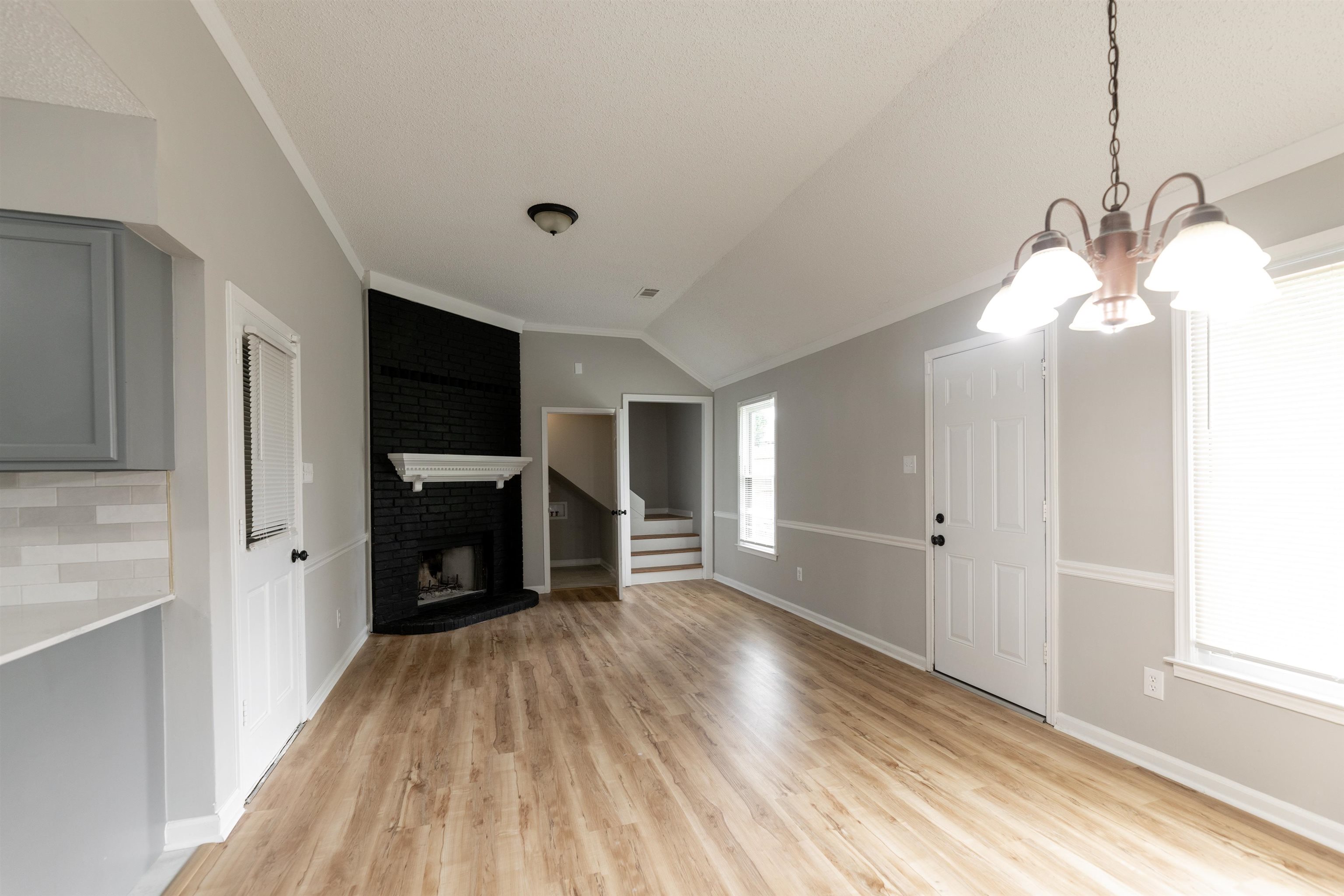 7421 Richmond Road Memphis, TN 38125 - Photo 11 of 39 Open concept living space featuring wood-finish flooring and vaulted ceilings