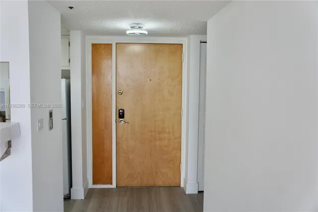 a view of hallway with wooden floor