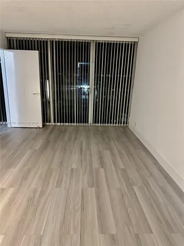 an empty room with wooden floor