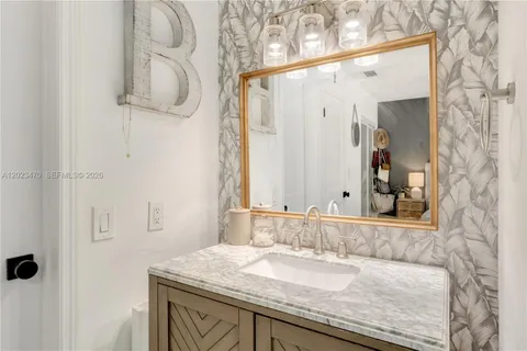 a bathroom with a sink a toilet and a mirror