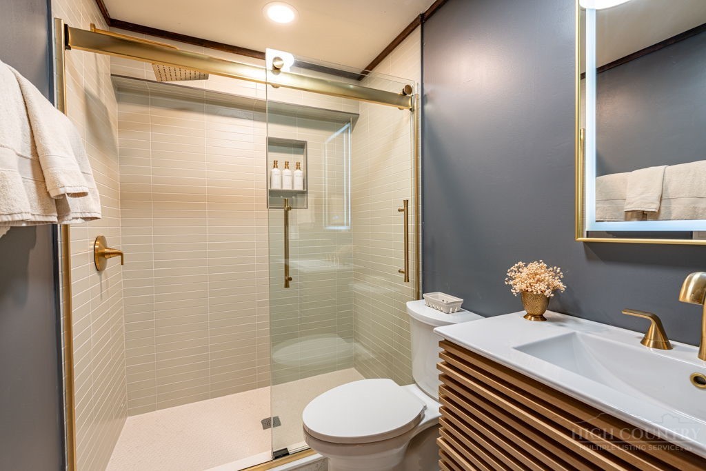102 Ridge Drive Linville, NC 28646 - Photo 43 of 48 a bathroom with a sink a toilet and shower