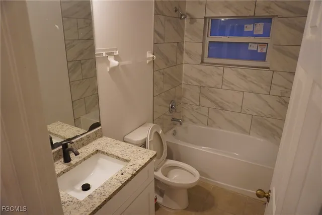 a bathroom with a sink mirror toilet and bathtub
