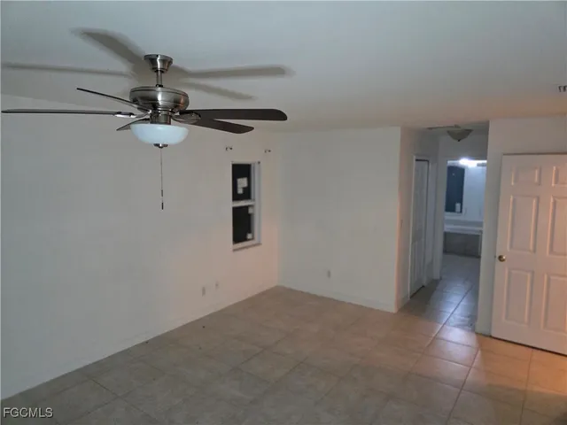 a view of a hallway with a chandelier fan