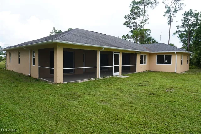 a view of an house with backyard space and balcony