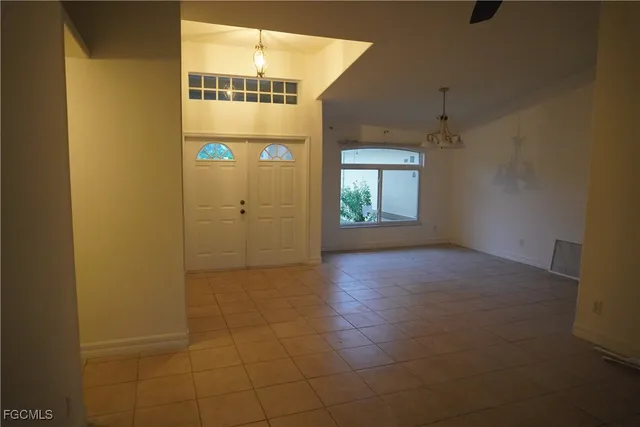 an empty room with windows and entrance