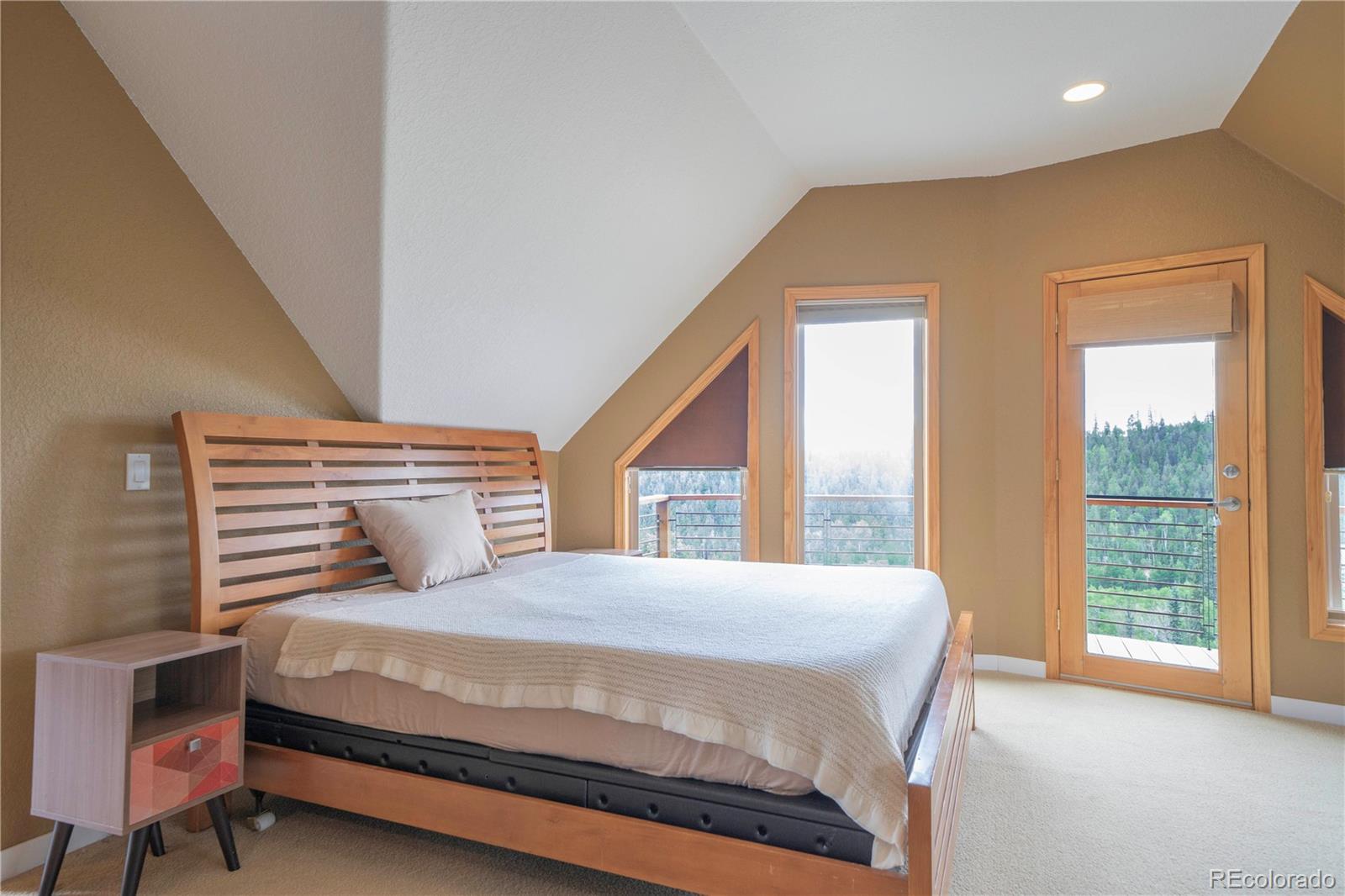 138 Teton Way Como, CO 80432 - Photo 12 of 34 a bedroom with a large bed and a large window