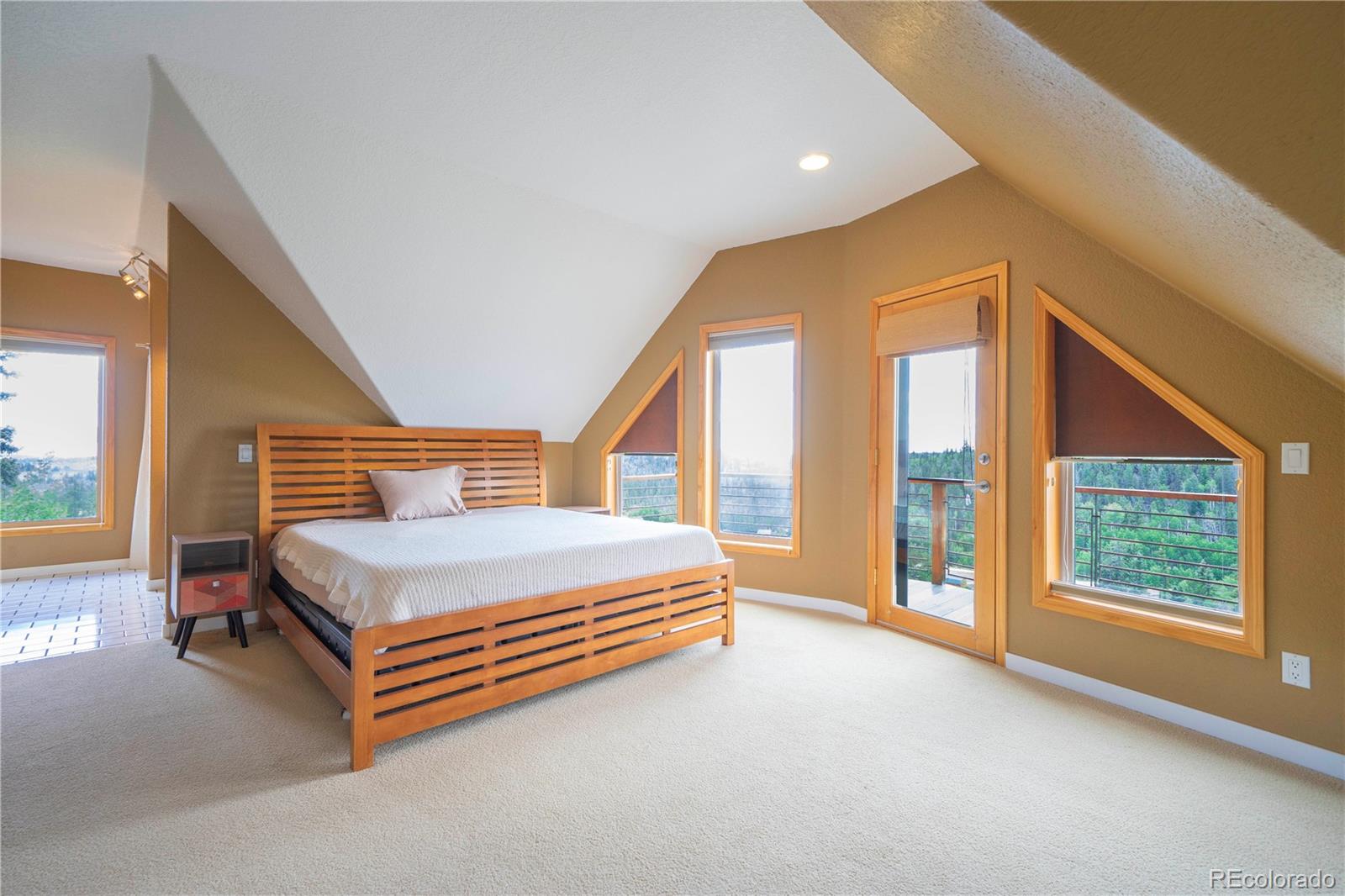 138 Teton Way Como, CO 80432 - Photo 13 of 34 a spacious bedroom with a bed and a large window