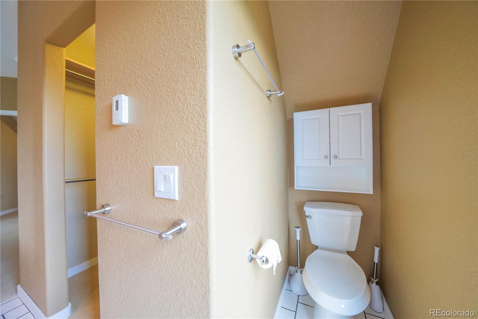138 Teton Way Como, CO 80432 - Photo 17 of 34 a white toilet sitting next to a bathroom sink