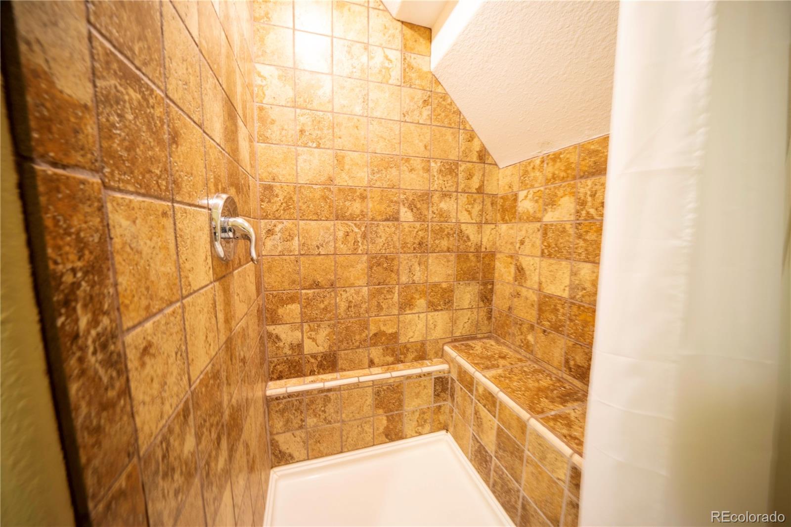 138 Teton Way Como, CO 80432 - Photo 21 of 34 a bathroom with a bathtub and shower