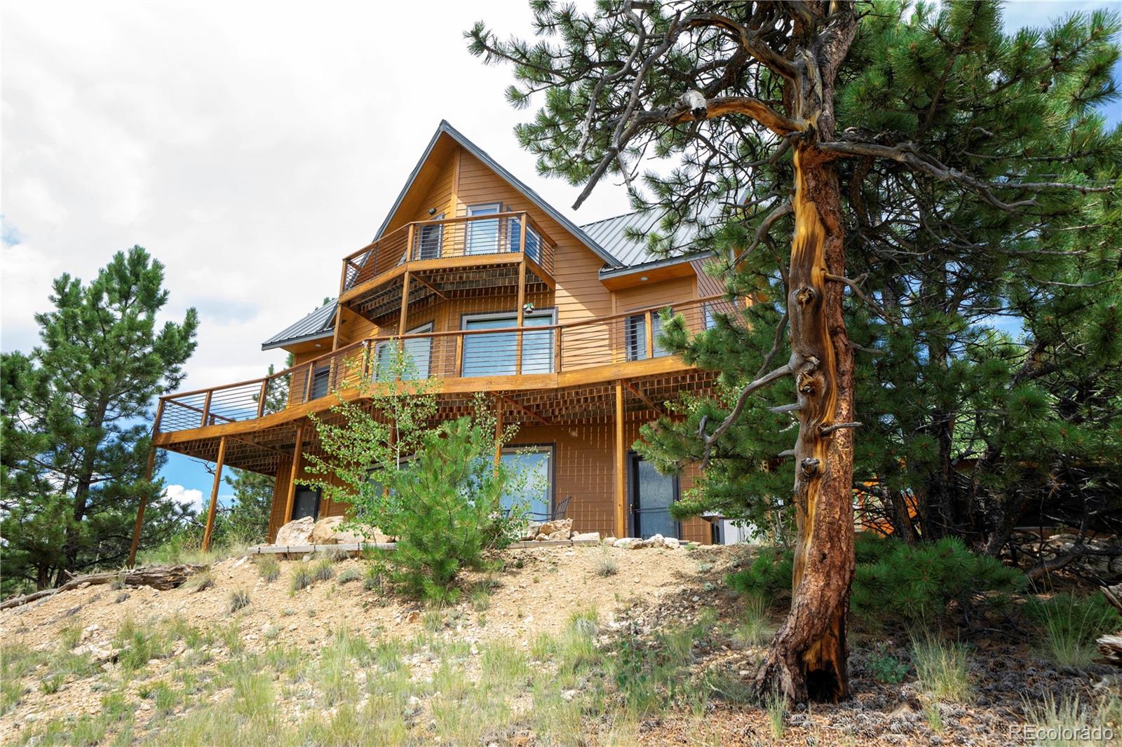 138 Teton Way Como, CO 80432 - Photo 28 of 34 a front view of a house with a yard and garage