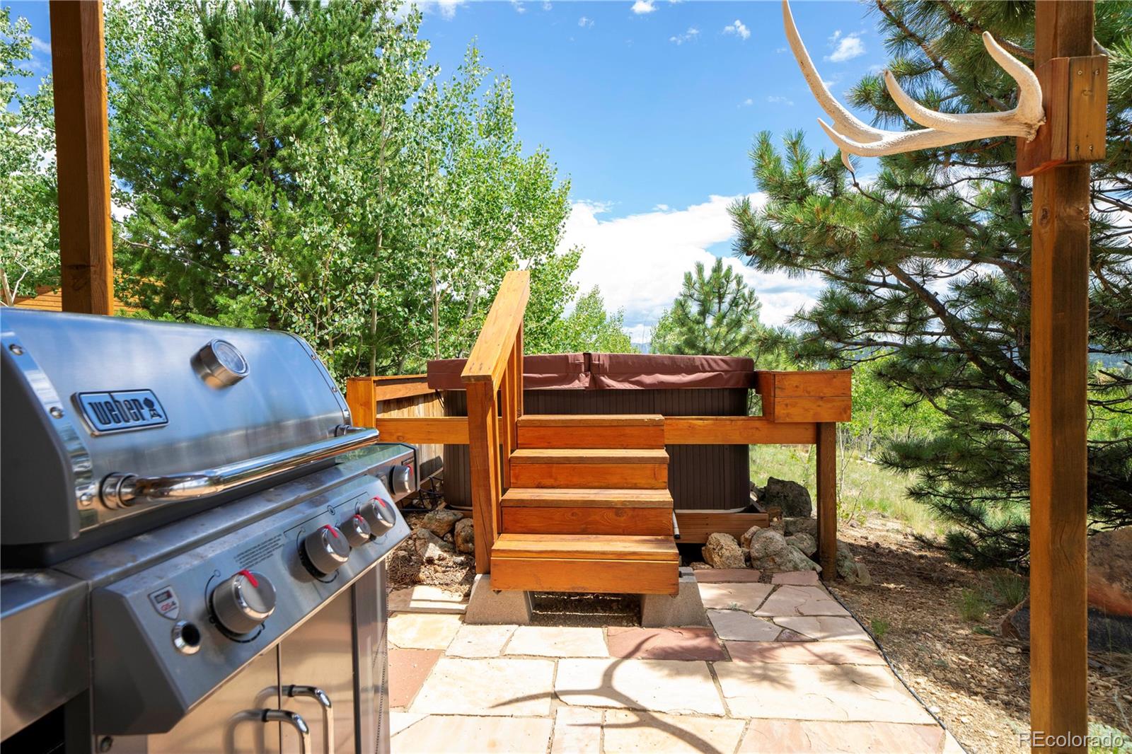 138 Teton Way Como, CO 80432 - Photo 31 of 34 a view of a patio with table and chairs with wooden floor and fence