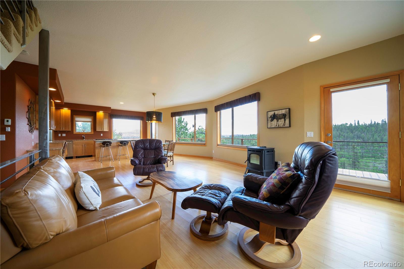 138 Teton Way Como, CO 80432 - Photo 32 of 34 a living room with furniture floor to ceiling window and a flat screen tv