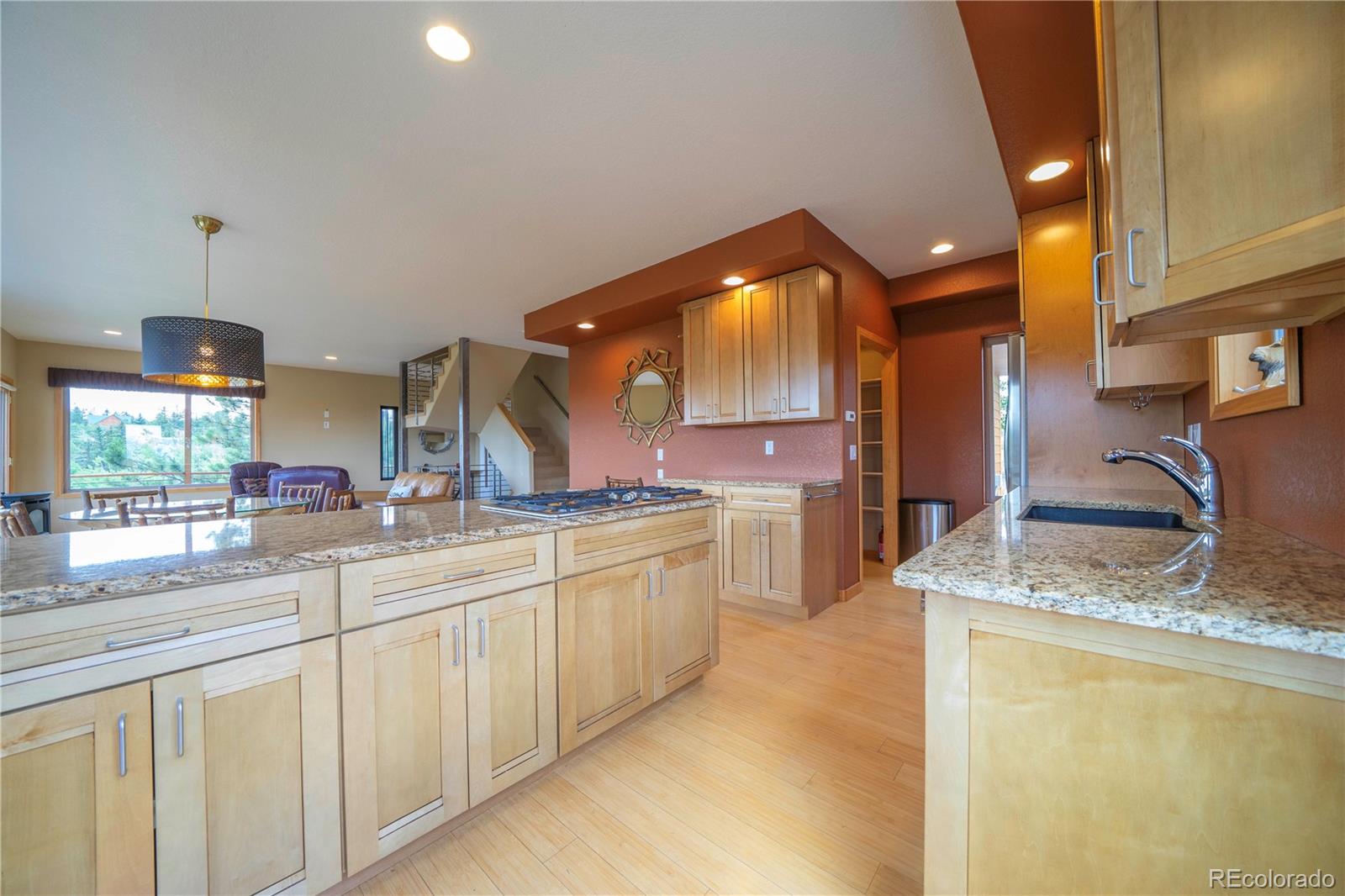 138 Teton Way Como, CO 80432 - Photo 10 of 34 a large kitchen with granite countertop a sink and a refrigerator