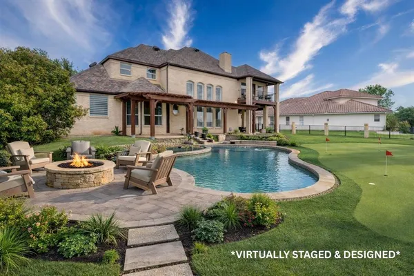 a view of a house with a swimming pool and sitting area