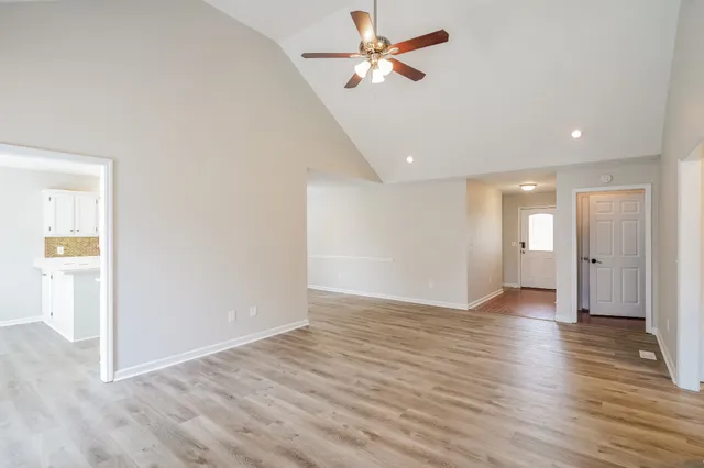 a view of empty room with wooden floor