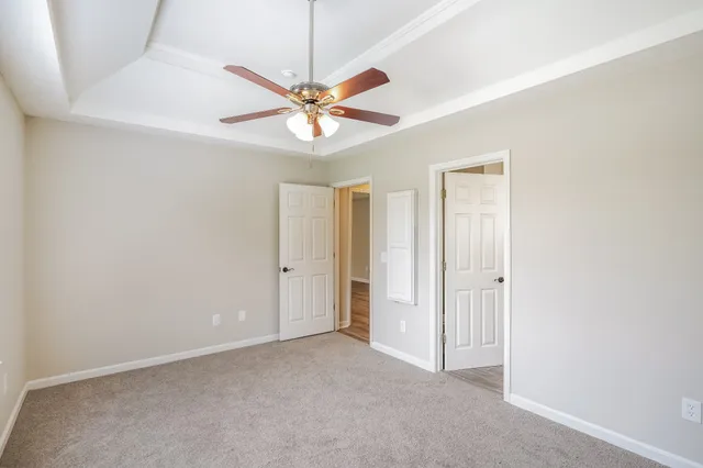 an empty room with a fan and a fan