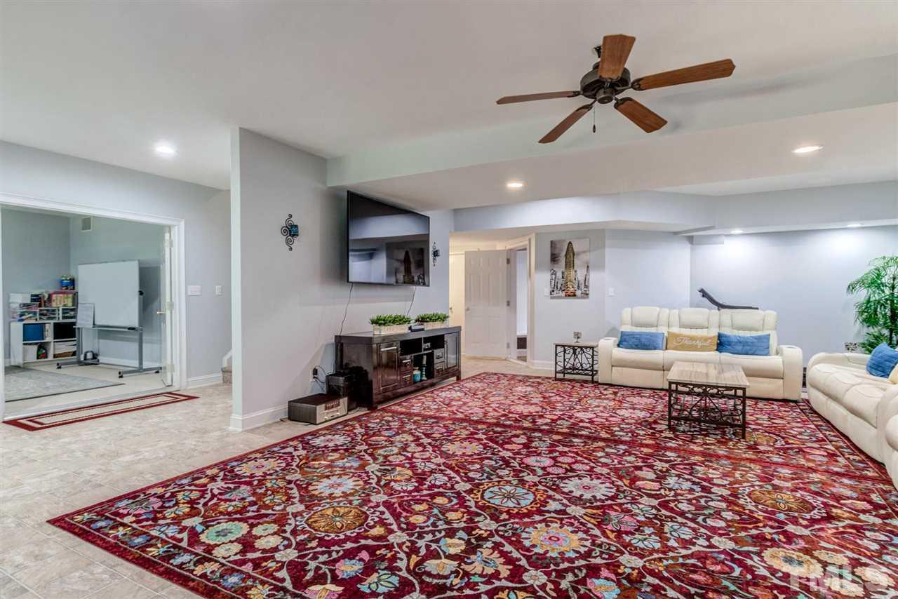 12249 Beestone Lane Raleigh, NC 27614 - Photo 11 of 29 a living room with furniture and a rug