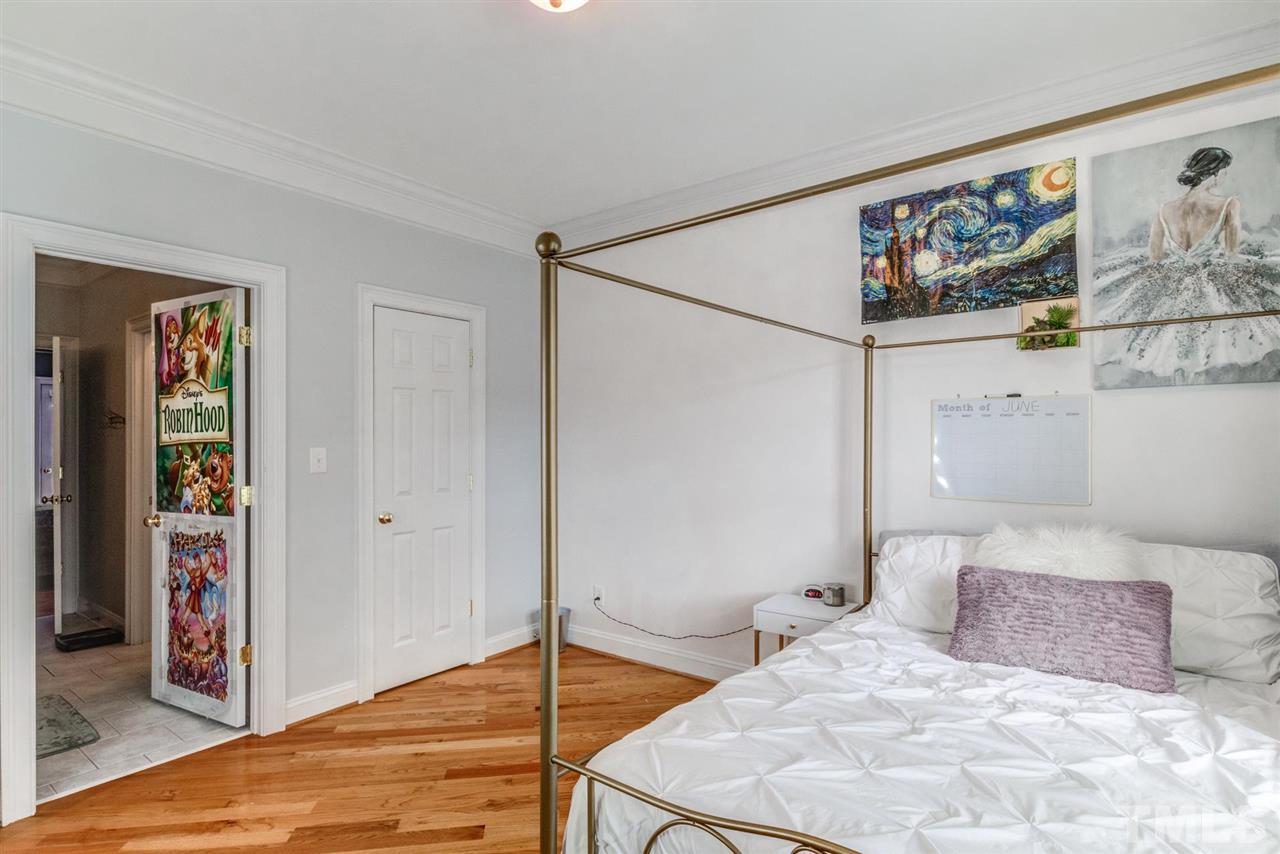 12249 Beestone Lane Raleigh, NC 27614 - Photo 22 of 29 a bedroom with a large bed and a painting on the wall