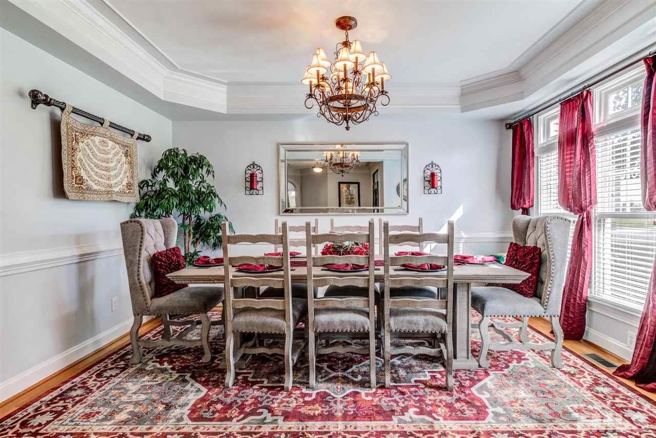 12249 Beestone Lane Raleigh, NC 27614 - Photo 4 of 29 a view of a dining room with furniture window and wooden floor
