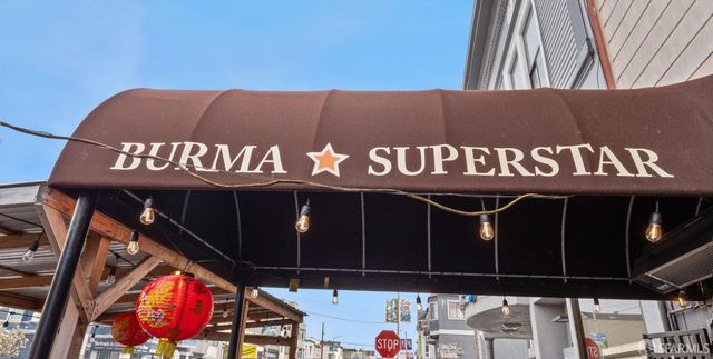 a view of a palm trees front of the house