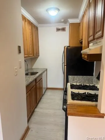 a kitchen with stainless steel appliances granite countertop a refrigerator and a stove