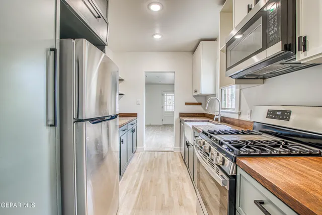 a kitchen with a sink stove and cabinets
