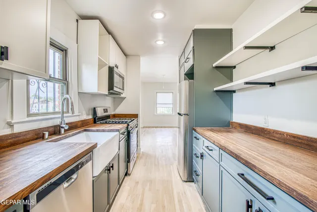 a kitchen with a sink a counter top space and cabinets