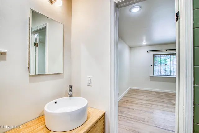 a backyard of a house with basket ball court and glass door