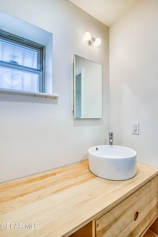 a backyard of a house with large trees and plants