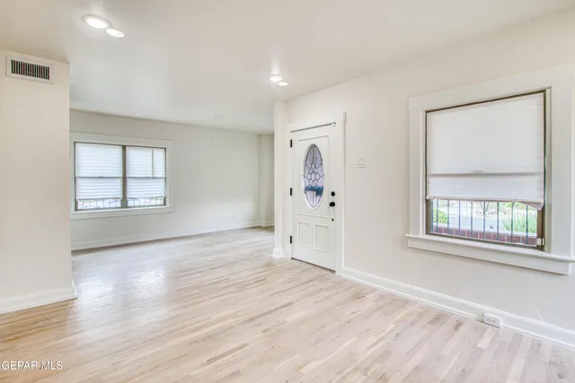 a view of a livingroom with fireplace and wooden floor