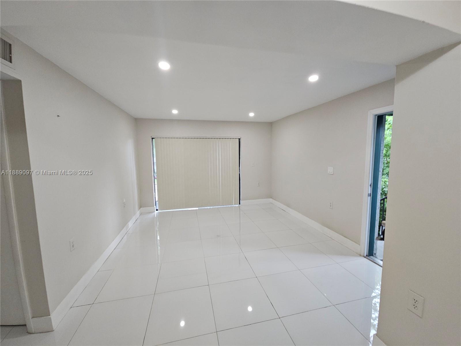 6901 Northwest 179th Street, Unit 212 Hialeah, FL 33015 - Photo 4 of 5 a view of an empty room