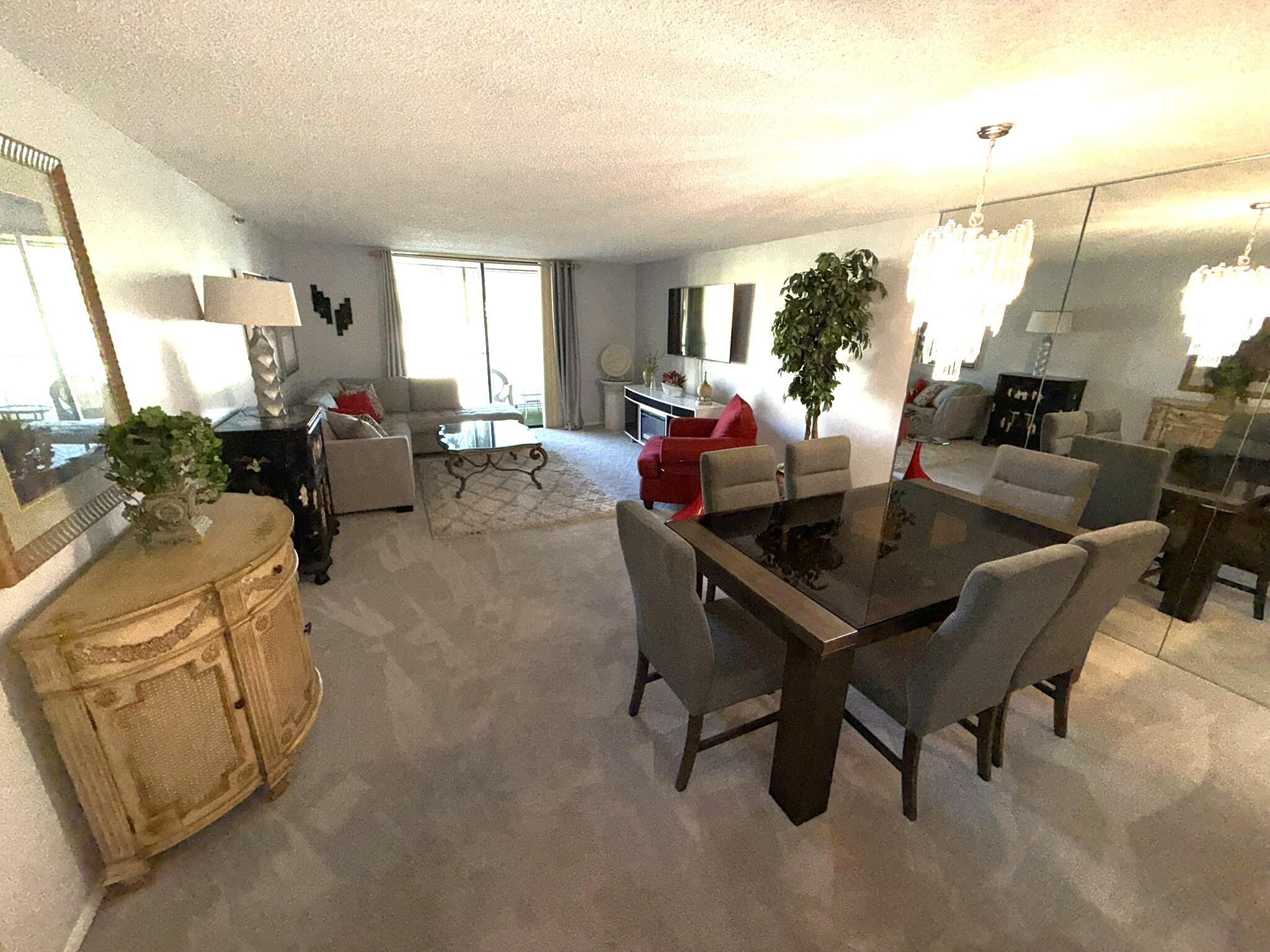 2788 Tennis Club Drive, Unit 203 West Palm Beach, FL 33417 - Photo 5 of 10 a living room with furniture and a window