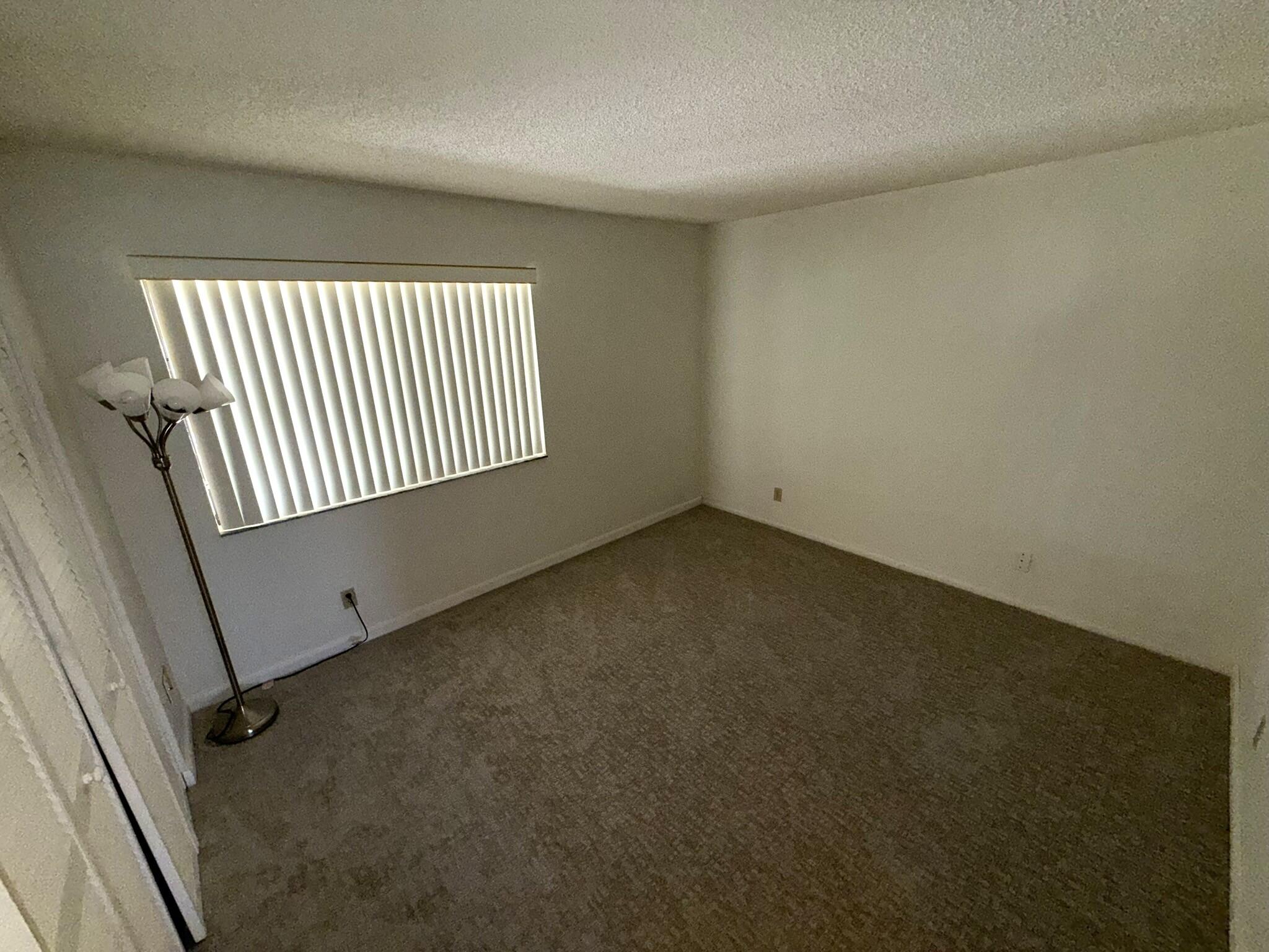 2788 Tennis Club Drive, Unit 203 West Palm Beach, FL 33417 - Photo 7 of 10 an empty room with windows