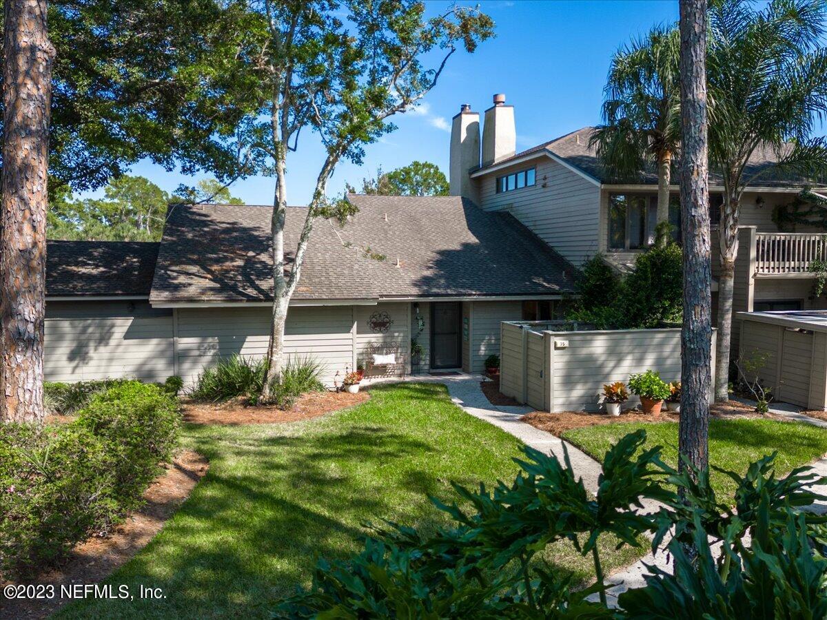 75 Fishermans Cove Road Ponte Vedra Beach, FL 32082 - Photo 2 of 47 a view of a house with a big yard potted plants and a large tree