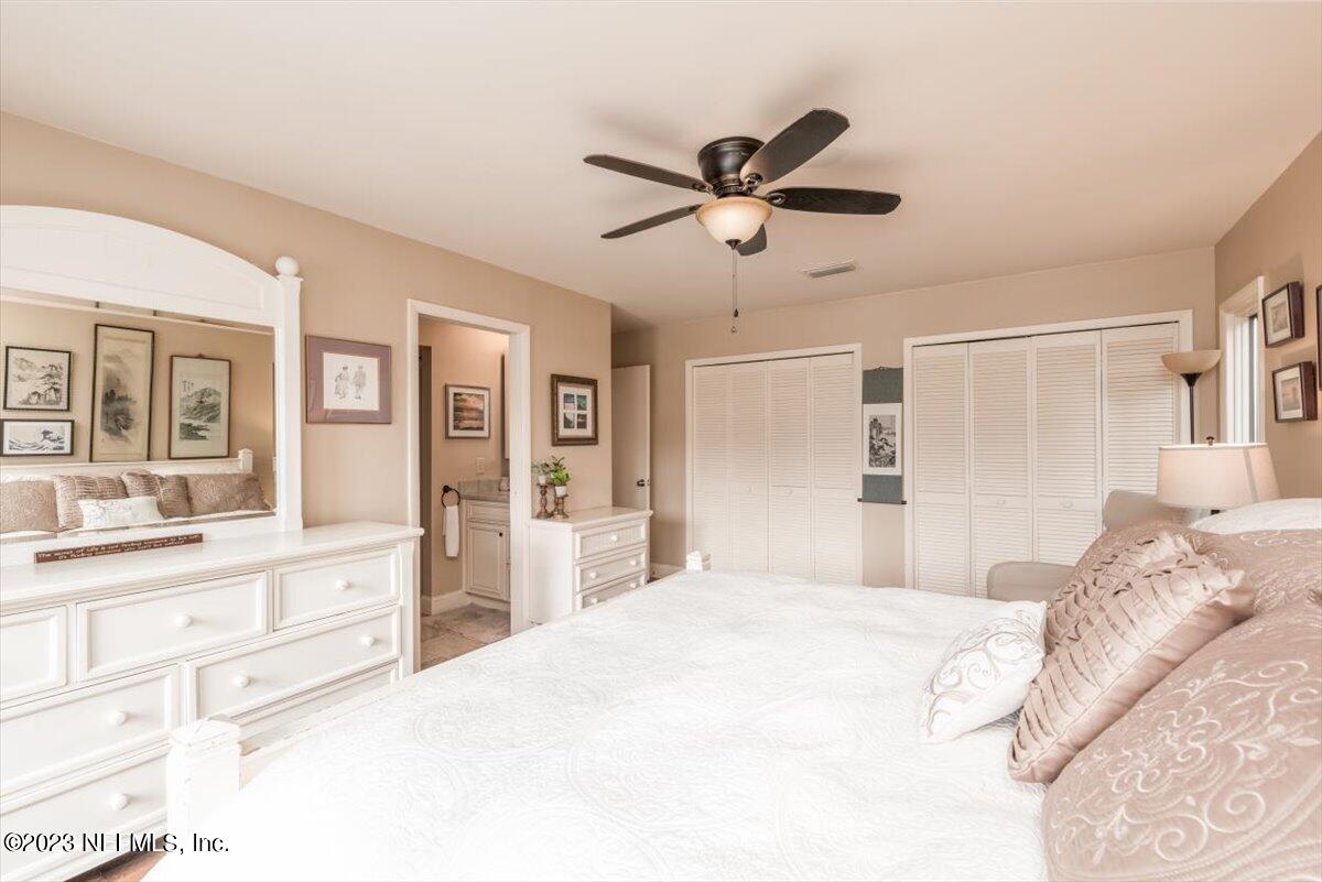 75 Fishermans Cove Road Ponte Vedra Beach, FL 32082 - Photo 21 of 47 a bedroom with a large bed and a chandelier