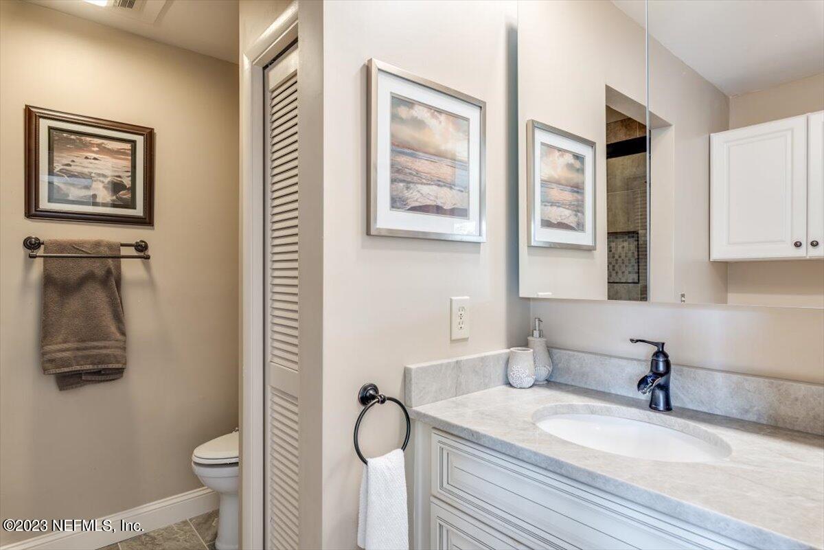75 Fishermans Cove Road Ponte Vedra Beach, FL 32082 - Photo 22 of 47 a bathroom with a granite countertop sink mirror vanity and toilet